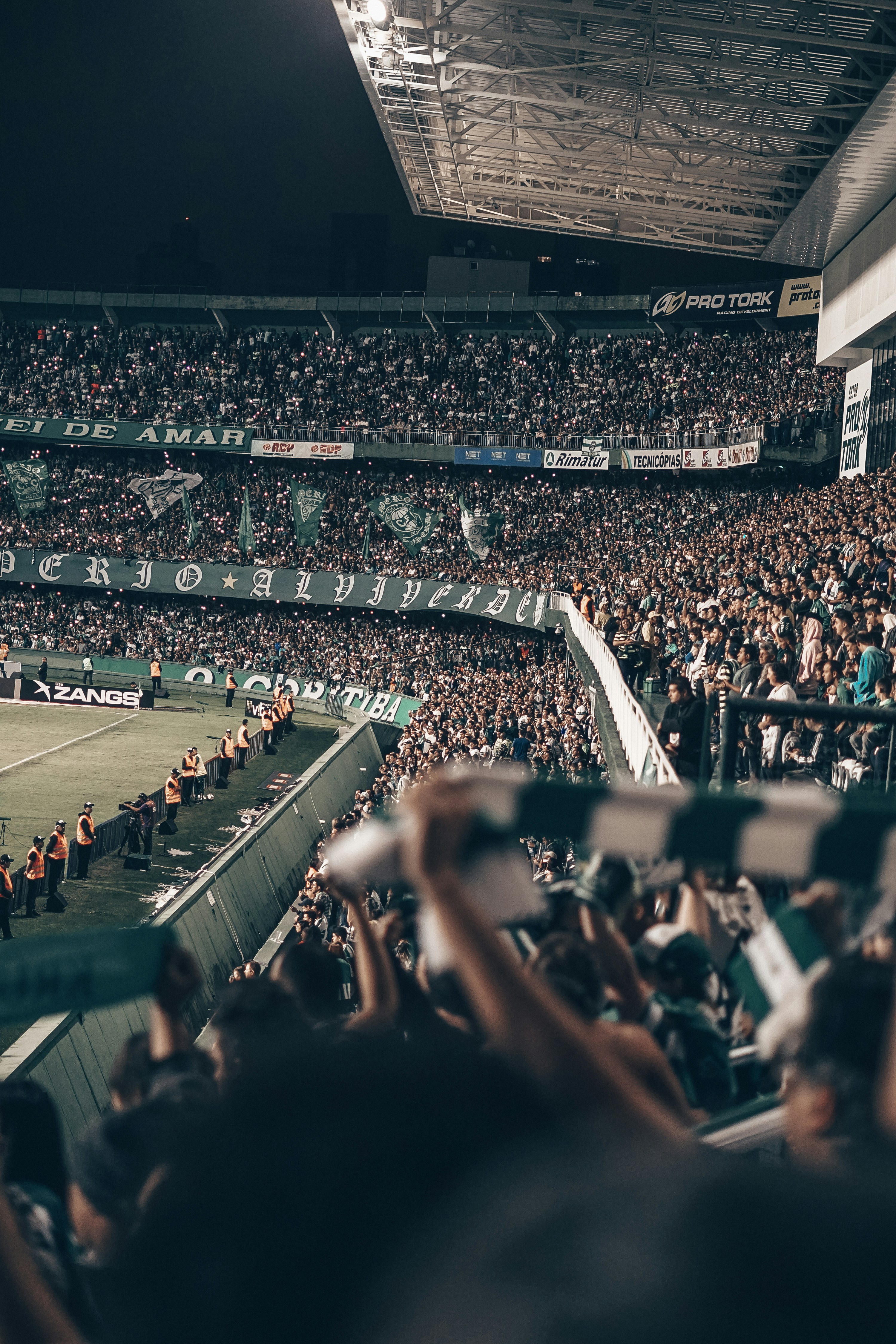 Stadium floodlights over the pitch at night